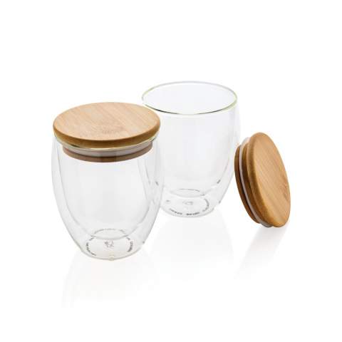 This double wall borosilicate glass set has a sleek 2 layer design which showcases all your favourite drinks! No matter what you serve, cappuccino, tea or latte will be nice and hot while your hand stays cool. Incudes a bamboo lid. It is recommended to handwash the glass and bamboo lid. Presented in a full colour gift box. Capacity per glass 250ml. BPA free.