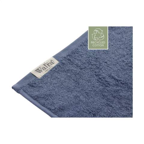 Stylish bath towel from the Walra brand. Made from 70% recycled cotton and 30% cotton (550 g/m²). This bath towel has a fine structure, an elegant border and a handy hanging loop. Wonderfully soft and absorbent. This product is Oeko-tex and GRS certified. The production of these bathroom textiles saves a lot of water and reduces CO2 emissions and energy through the reuse of materials. This is confirmed by the independent REMO quality mark.