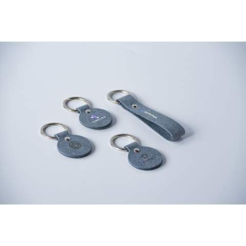 Keyring from the MADE out of brand. This keyring is made from recycled denim fibres: 70% denim waste, 25% binders and 5% vegetable additives. It has a fine, modern-looking texture. Fine fibres make this flexible material comparable to real leather. It is 100% recyclable and can be reused repeatedly. Due to the use of denim waste, mainly from the Netherlands and Germany, this product has a blue colour. Supplied with a sturdy metal keyring. A recyclable product with a contemporary look. Handmade. Dutch design. Made in Holland.