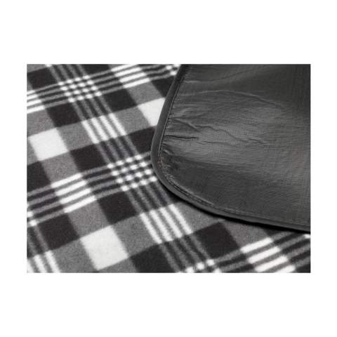 WoW! Picnic blanket with a beautiful chequered pattern. The top layer is very soft and made from 100% RPET (130 g/m²). The underside is made from water-repellent PEVA and protects against moisture and dirt.  Supplied with a zipper pocket, carrying strap and Velcro close. Easy to fold up and carry. GRS-certified. Total recycled material: 55%. Dimensions when unfolded 121 x 135 cm.