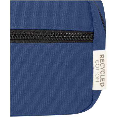 Travel accessory pouch made of GRS certified recycled canvas and GRS certified RPET lining. Featuring a zippered front pocket and one zippered main compartment with organisational pockets, and a comfortable webbing. The decorative metal plate can make a logo shine through its subtle and matt finish. Capacity: 3.5 litres.